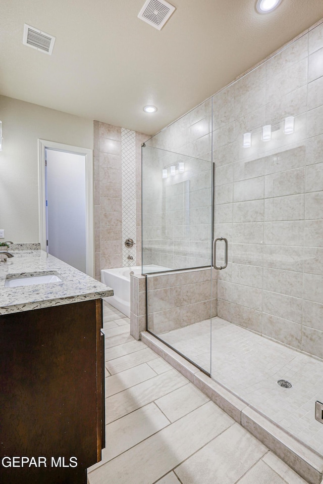 14940 Tierra Escape Ave, El Paso, TX 79938 - full bath featuring tile patterned floors, visible vents, a shower stall, and a garden tub