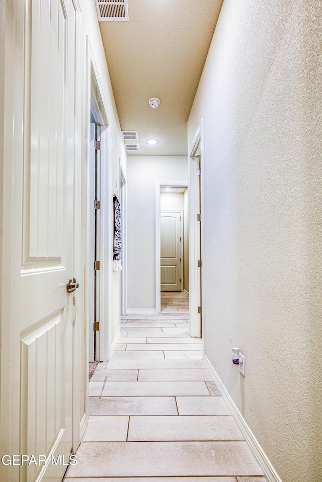 14940 Tierra Escape Ave, El Paso, TX 79938 - corridor with wood tiled floor, baseboards, and visible vents