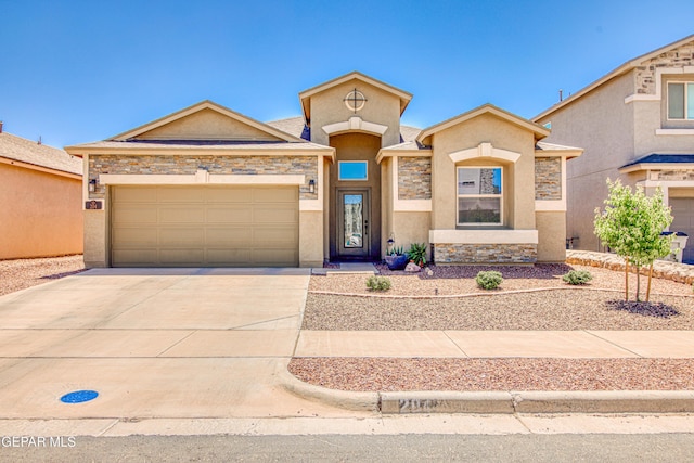 mediterranean / spanish-style house featuring concrete driveway, an attached garage, stone siding, and stucco siding