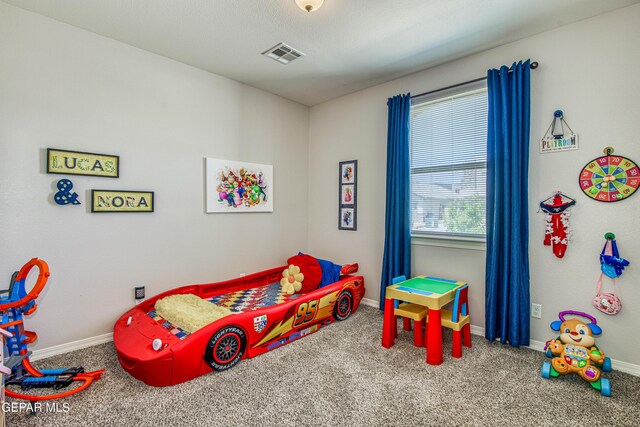carpeted bedroom featuring visible vents and baseboards