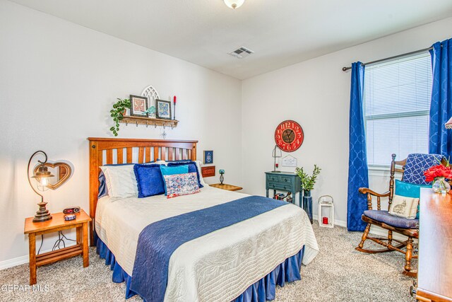 bedroom with carpet floors, baseboards, and visible vents