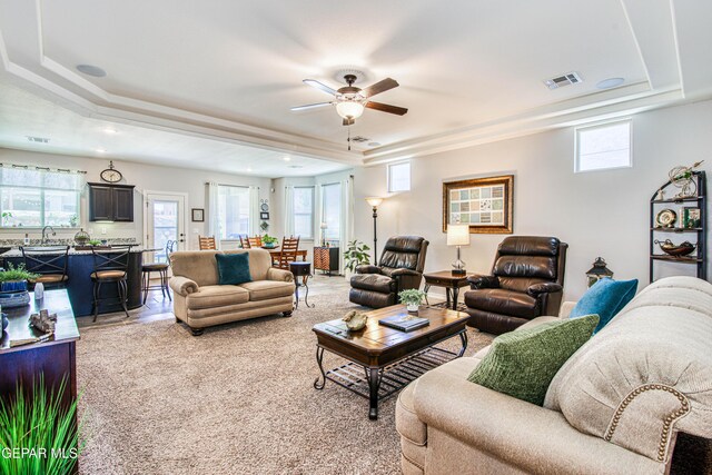 living room featuring ceiling fan, light colored carpet, recessed lighting, a tray ceiling, and visible vents