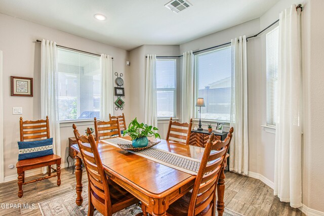 dining room with visible vents, recessed lighting, baseboards, and wood finished floors