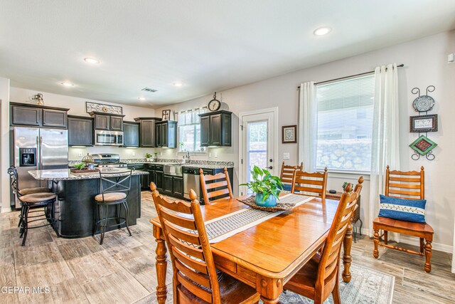 dining area featuring recessed lighting, baseboards, visible vents, and light wood-style floors