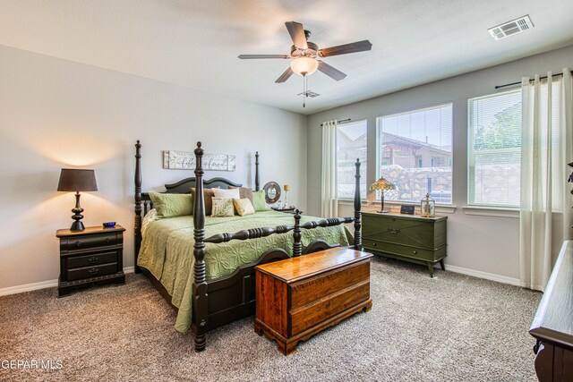 bedroom with baseboards, light colored carpet, and visible vents