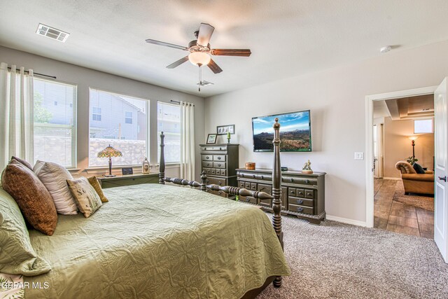 bedroom featuring a ceiling fan, baseboards, visible vents, and carpet