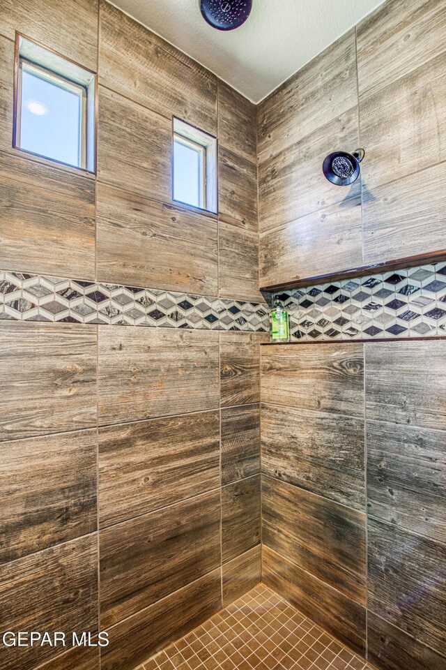 full bathroom with a tile shower