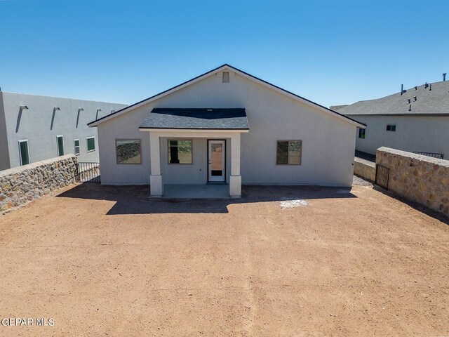 3817 Course St, El Paso, TX 79938 - view of front of property with roof with shingles, a fenced backyard, a patio area, and stucco siding