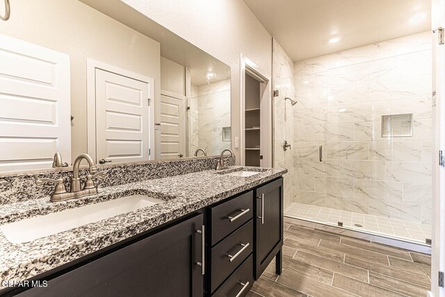 3817 Course St, El Paso, TX 79938 - full bath with double vanity, wood tiled floor, a sink, and a stall shower