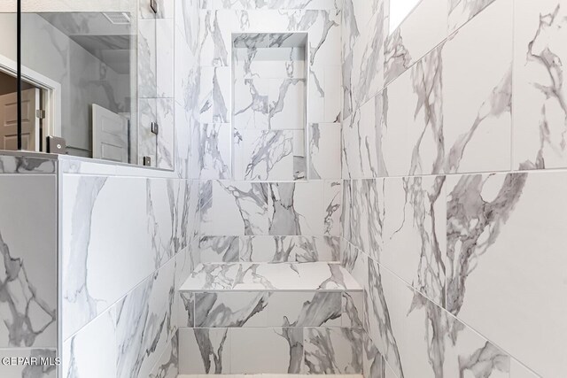 full bath with a tile shower