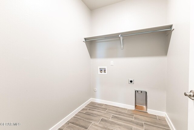 laundry area with washer hookup, wood tiled floor, laundry area, hookup for an electric dryer, and baseboards