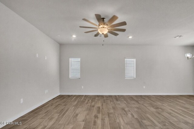 unfurnished room featuring baseboards, recessed lighting, ceiling fan, and wood finished floors