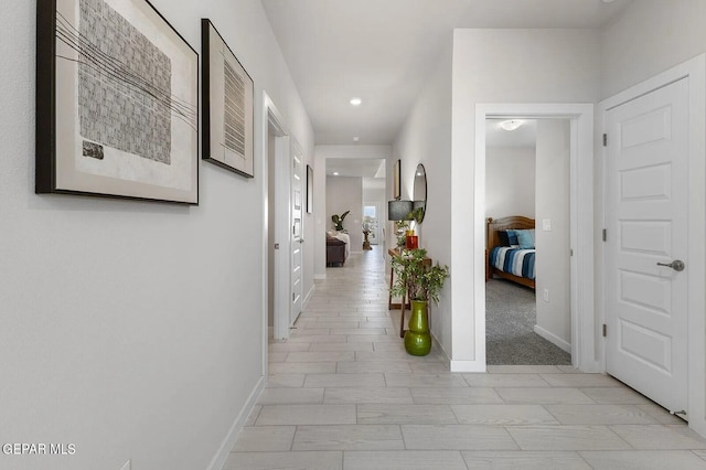 corridor with baseboards and recessed lighting
