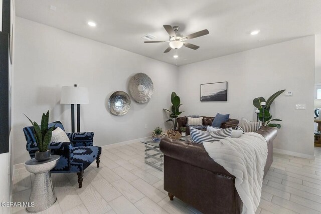 living room featuring recessed lighting, ceiling fan, visible vents, and baseboards