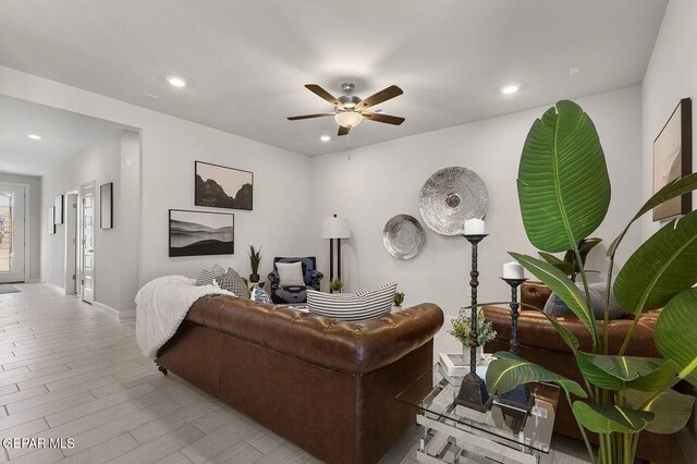 living area featuring recessed lighting, baseboards, ceiling fan, and wood finished floors