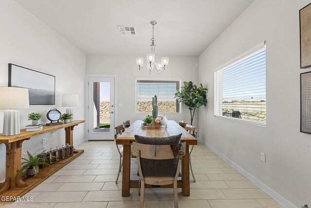 dining space featuring an inviting chandelier, baseboards, and visible vents