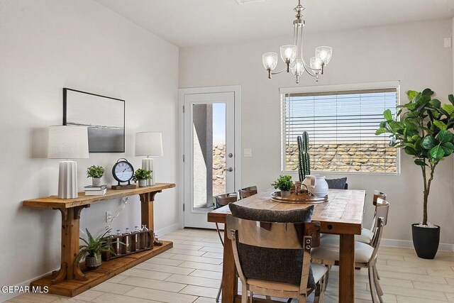 dining room with baseboards and an inviting chandelier
