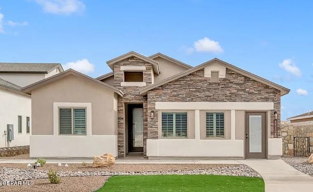 view of front of home featuring stone siding and stucco siding
