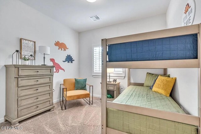 bedroom featuring light colored carpet, baseboards, and visible vents