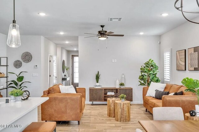 living area featuring ceiling fan, recessed lighting, light wood-style flooring, and visible vents