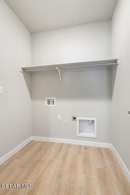 laundry room with hookup for an electric dryer, laundry area, hookup for a washing machine, and light wood-type flooring