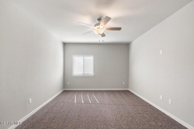 spare room featuring carpet floors, ceiling fan, baseboards, and visible vents
