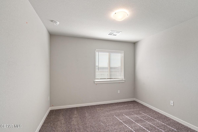 carpeted empty room with baseboards and visible vents