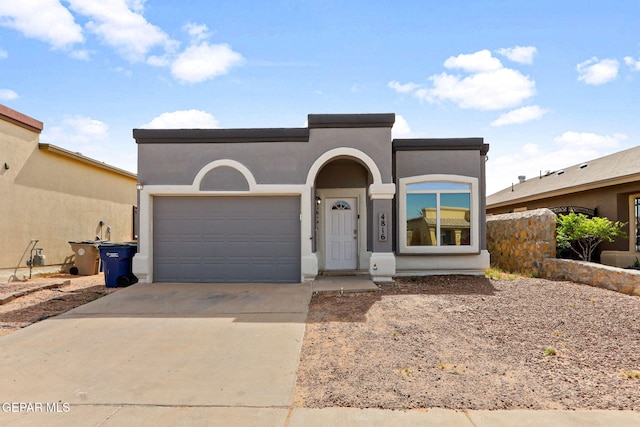 view of front of home featuring a garage, stucco siding, and driveway