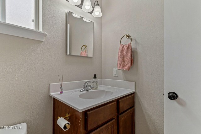 bathroom featuring toilet and vanity