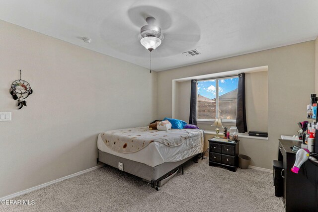 bedroom featuring a ceiling fan, baseboards, visible vents, and carpet