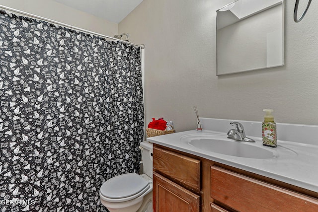bathroom with toilet, curtained shower, and vanity