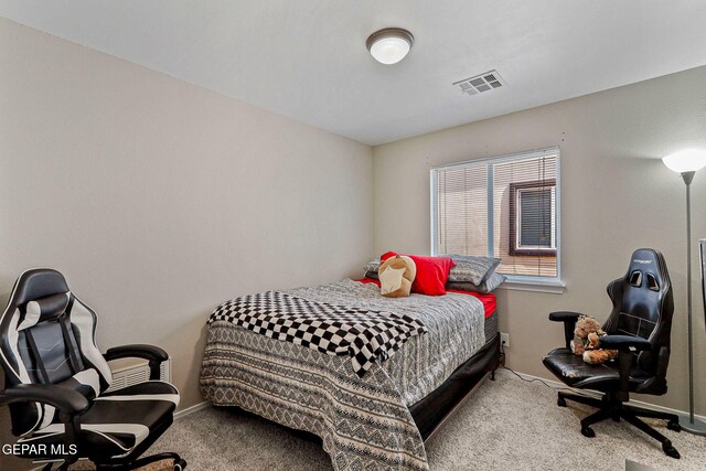 carpeted bedroom with visible vents and baseboards