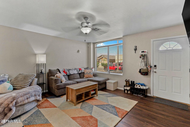 living area featuring baseboards, a ceiling fan, wood finished floors, and visible vents