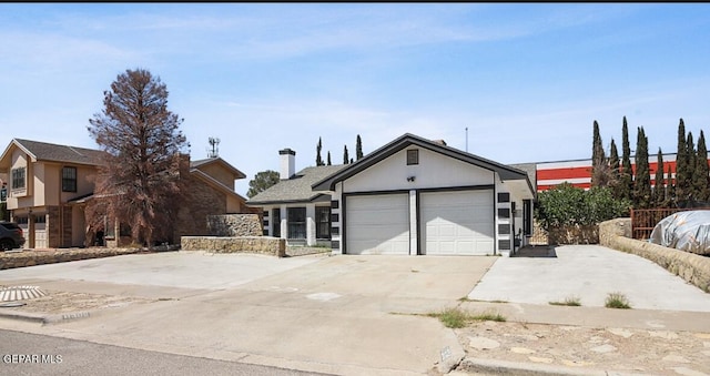ranch-style house featuring concrete driveway and a garage