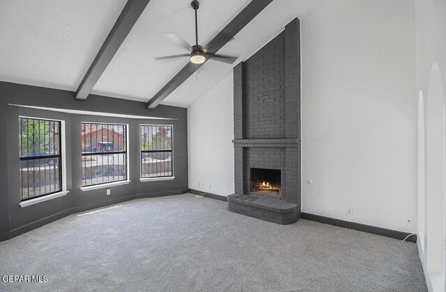 unfurnished living room featuring a brick fireplace, baseboards, ceiling fan, vaulted ceiling with beams, and carpet
