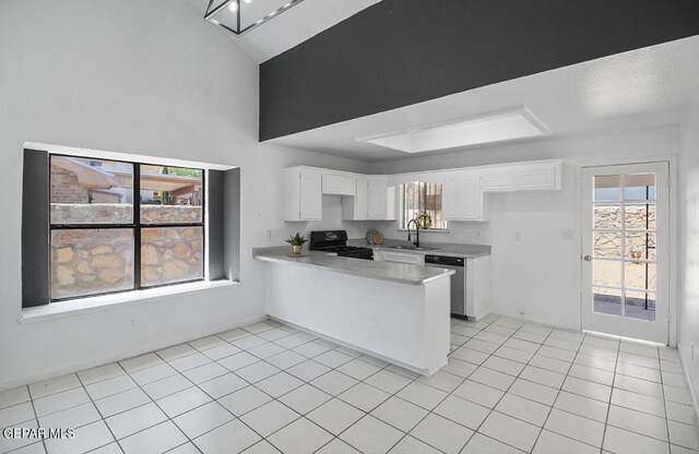 kitchen with a sink, black range oven, dishwasher, a peninsula, and white cabinetry