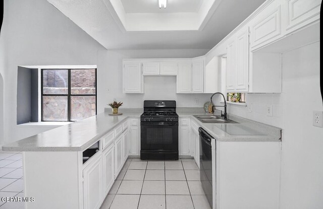 kitchen featuring a peninsula, light tile patterned flooring, a raised ceiling, a sink, and black appliances