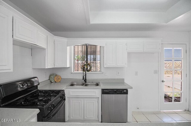 kitchen featuring white cabinets, a sink, dishwasher, light countertops, and black gas stove