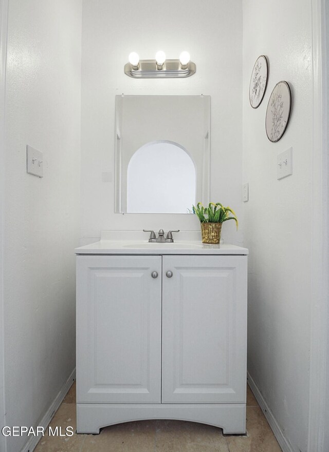 bathroom featuring baseboards and vanity