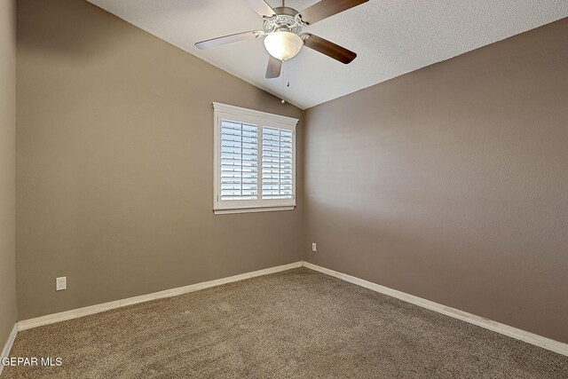 carpeted spare room with ceiling fan, baseboards, and lofted ceiling