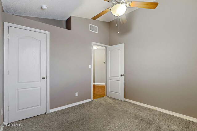 unfurnished bedroom with baseboards, visible vents, ceiling fan, and carpet