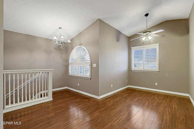 empty room featuring plenty of natural light, wood finished floors, and lofted ceiling