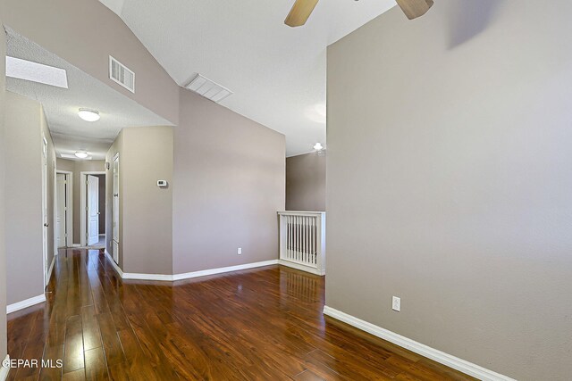 unfurnished living room with baseboards, ceiling fan, hardwood / wood-style flooring, and visible vents