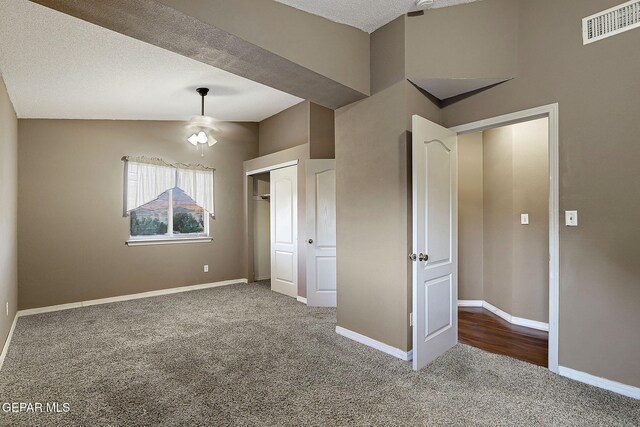 unfurnished bedroom with carpet floors, baseboards, a closet, and visible vents