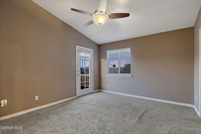 empty room featuring vaulted ceiling, baseboards, a ceiling fan, and carpet flooring