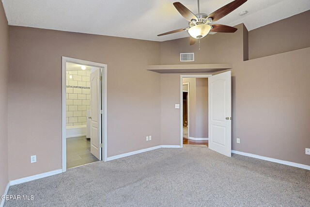 unfurnished bedroom with visible vents, connected bathroom, baseboards, and carpet floors