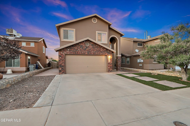 view of front facade with stone siding, a garage, stucco siding, cooling unit, and driveway