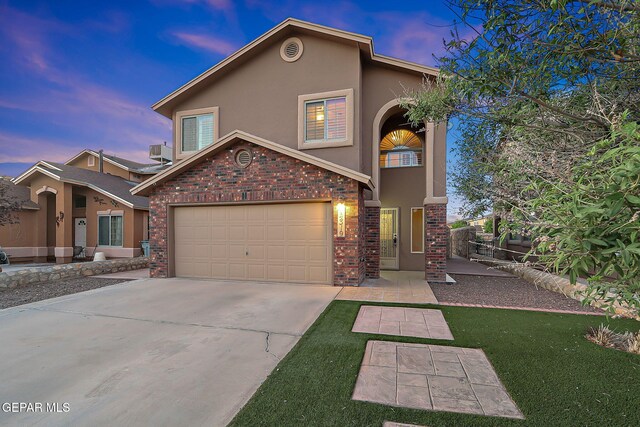 view of front of home with brick siding, central AC, stucco siding, and concrete driveway