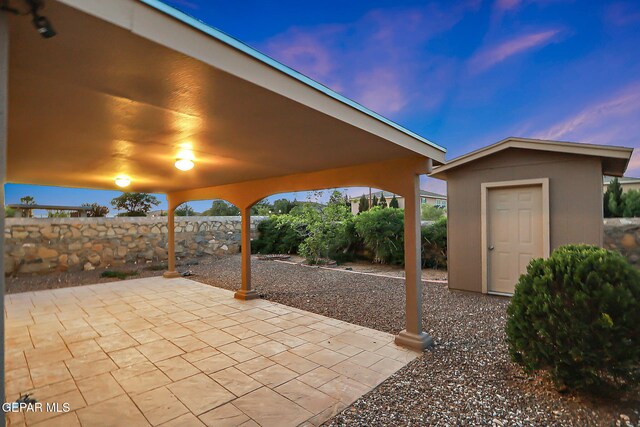 view of patio with fence and an outbuilding