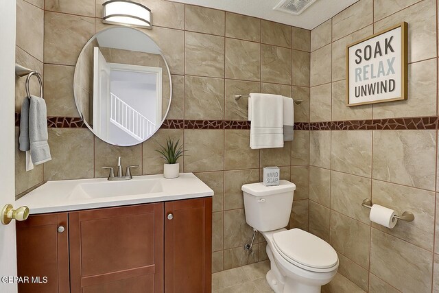 14319 Island Point Dr, El Paso, TX 79938 - half bathroom featuring tile walls, toilet, and vanity